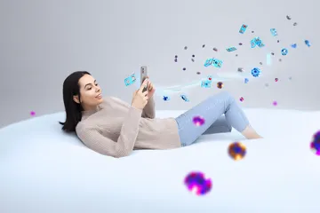 A cheerful woman in traditional clothing using her smartphone during a festive moment, showing how easily the JILI7979 app fits into everyday life.